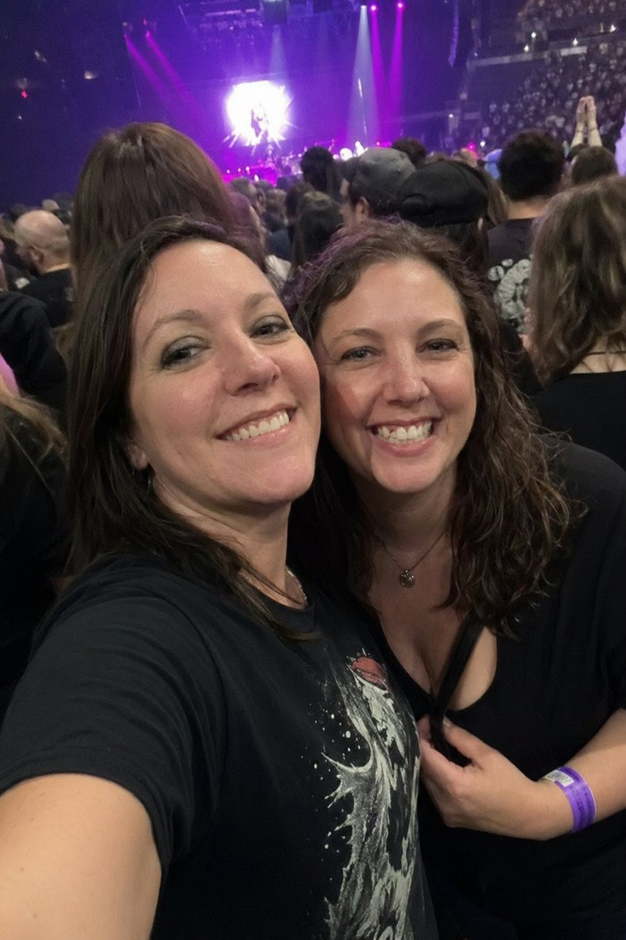 Concert fans taking a selfie in arena lights