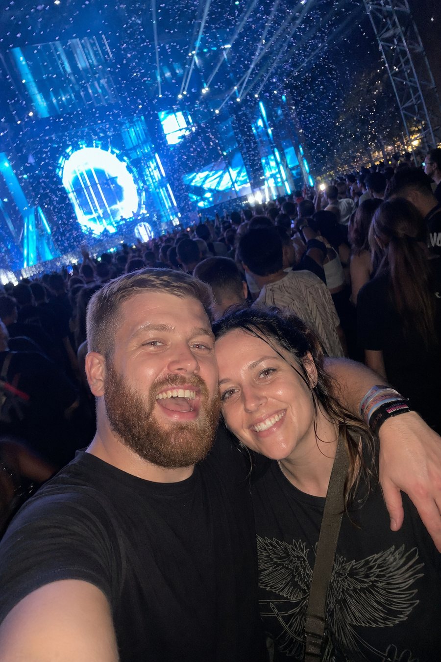 Festival fans taking a selfie with stage lights